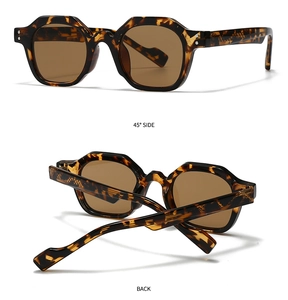 Macro detail of tortoiseshell sunglasses frame with reinforced hinge and brown lenses