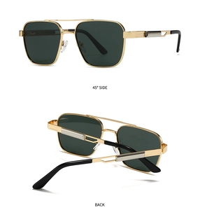 Detail of aviator sunglasses with gold metal frame, dark green lenses and mechanical hinge