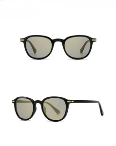 Detail view showing black frame sunglasses with golden metal hinges and yellow lenses