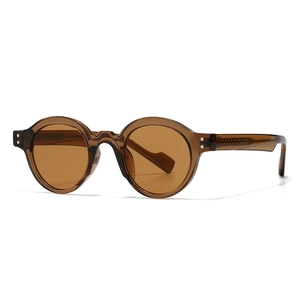 Retro round amber frame sunglasses with dark brown lenses and metal rivet details