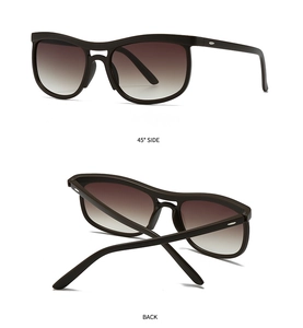 Detail view of dark brown cat-eye sunglasses with silver oval accent and gradient lenses
