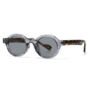 Retro round sunglasses with grey scalloped frames and tortoiseshell temples shown at a 45-degree angle