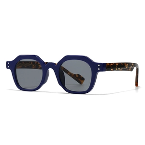 Retro geometric sunglasses with dark blue frame and tortoise shell temples from a 45-degree angle