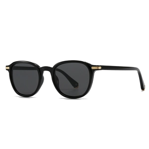 Retro black round-frame sunglasses with elegant gold metal temple accents on white background