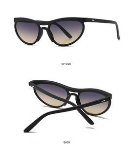 Detail view of modern cat eye sunglasses with matte black frame and purple-yellow gradient lens