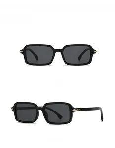 Close-up of black square sunglasses with dark polarized lenses and gold metal hinges