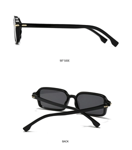 Detail view of glossy black square sunglasses with side gold metal rivets and back fold