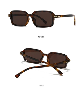 Detail view of tortoiseshell rectangular sunglasses featuring stylish gold metal accents