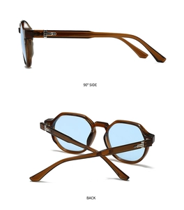 Detail view of tortoiseshell polygon sunglasses with blue lenses and silver arrow accents