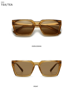 Detail view of tea-colored square sunglasses with translucent amber frames for men
