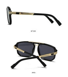 Detail view showing golden metal temples and black frame of modern oversized sunglasses