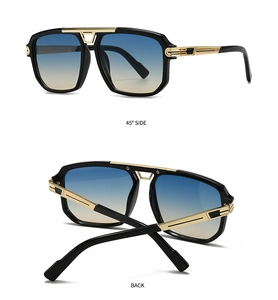 Macro detail of pilot sunglasses with black frame, gold temples and gradient lenses