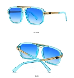 Detail view of large retro square sunglasses with light blue frames and gold metal temples
