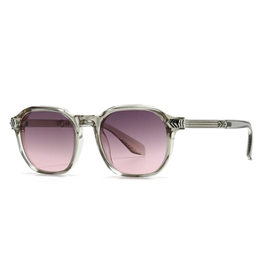 Fashionable round-frame sunglasses with translucent grey frames and pink purple gradient lenses