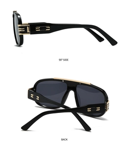 Detail of square vintage sunglasses with black frame and golden metal hinge design