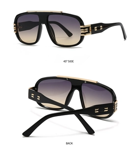 Detail view of large pilot sunglasses with gold metal accents and gradient lenses