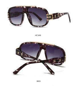 Detail view of large marble texture sunglasses with purple gradient lenses and gold accents