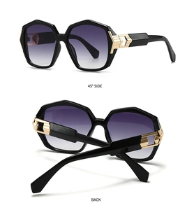 Detail view of hexagonal sunglasses showing 45-degree side angle and gold metal hinge accents