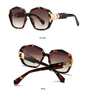 Detail of tortoiseshell sunglasses with golden hollow metal hinges and gradient lenses