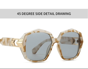 Detail view of tortoiseshell geometric sunglasses with metallic hinge and gray lenses