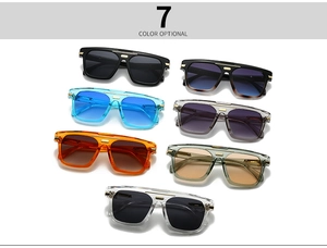 Detail of seven colored oversized retro sunglasses with metal top bar accents