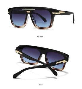 Detail view of bold black square frame sunglasses with golden lightning metal accents