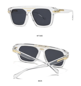 Detail view of transparent sunglasses with gold metal accents and dark grey lenses