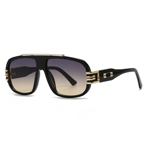 Modern oversized pilot sunglasses with black frame, gold accents and gradient lenses