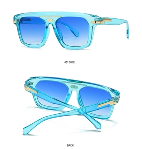Side and back view of blue oversized sunglasses with gold metal decorative accents