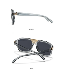 Detail view of pilot sunglasses with grey translucent frames and golden T-shaped metal hinges