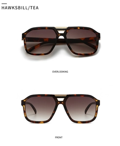 Macro view of retro tortoise frame navigator sunglasses with brown gradient lenses
