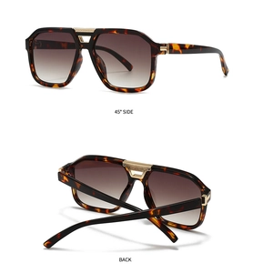 Detail view of tortoiseshell aviator sunglasses with gold metal trim and brown gradient lenses