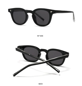 Detail view of black square sunglasses with silver accents and foldable temples
