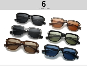 Close-up of golden cross arrow hinges on multi-colored retro square frame sunglasses
