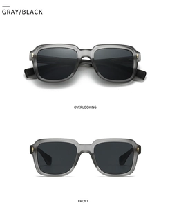 Detail view of grey translucent frame sunglasses with signature gold arrow rivets