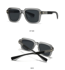 Detail view of transparent grey sunglasses with side gold accents and 45-degree angle