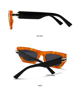 Detail view of retro square tortoise frame sunglasses with golden metal hinge accents