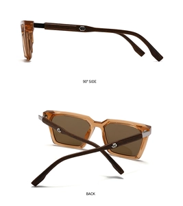 Détail des lunettes de soleil ambre avec branches effet bois et logo argenté