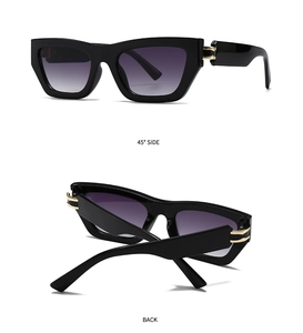 Detail view of square black sunglasses with purple gradient lenses and gold hinge accents