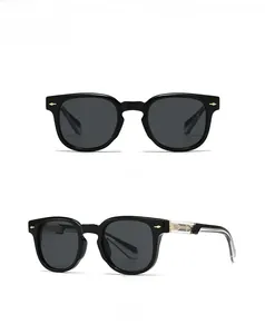 Detail view of black vintage sunglasses with arrow rivets and translucent temple arm