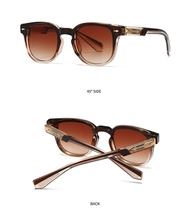 Detail of gradient brown frame and golden metal arrow hinge on retro sunglasses