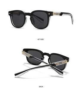Detail view of vintage sunglasses with transparent temples and gold arrow metal accents