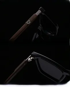 Detail of metal hinge and wooden texture temples on black polarized sunglasses