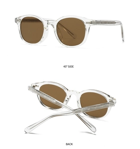 Detail view of transparent retro round sunglasses with brown lenses and visible metal core