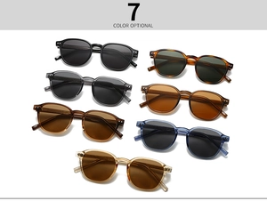 Close-up of seven vintage round sunglasses in various colors with metal rivet details