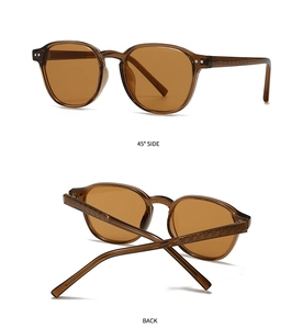 Detail of amber round sunglasses featuring diamond-patterned engraved temples and brown lenses