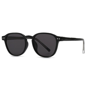 Classic round frame black sunglasses with silver double rivets and dark lenses on white background