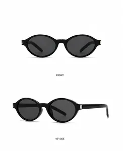 Detail view of oval sunglasses featuring black frames and silver metal hinge decor