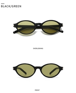 Detailed view of black oval sunglasses with green lenses and silver hinge accents