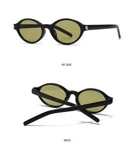Detail view of oval sunglasses featuring black frames and green lenses at a 45-degree angle